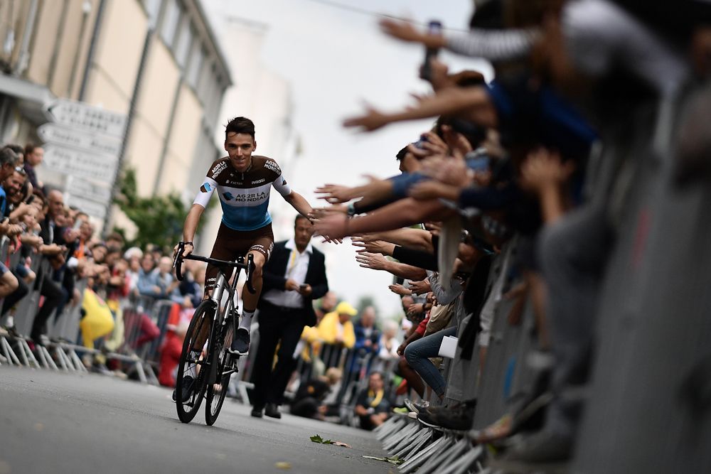 Romain Bardet greets fans on is way to the stage at the 2018 Tour de France team presentation