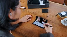 Samsung Galaxy Z Fold 3 used by woman on coffee table