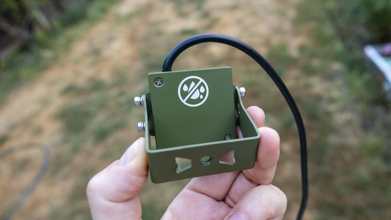 Close up of the Green Feathers TV connectable wildlife camera held in a female hand