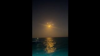 Debris caused by the breakup of the SpaceX Starship Flight 9 upper stage rains down over The Bahamas in this view, captured by journalist Stefanie Waldek.