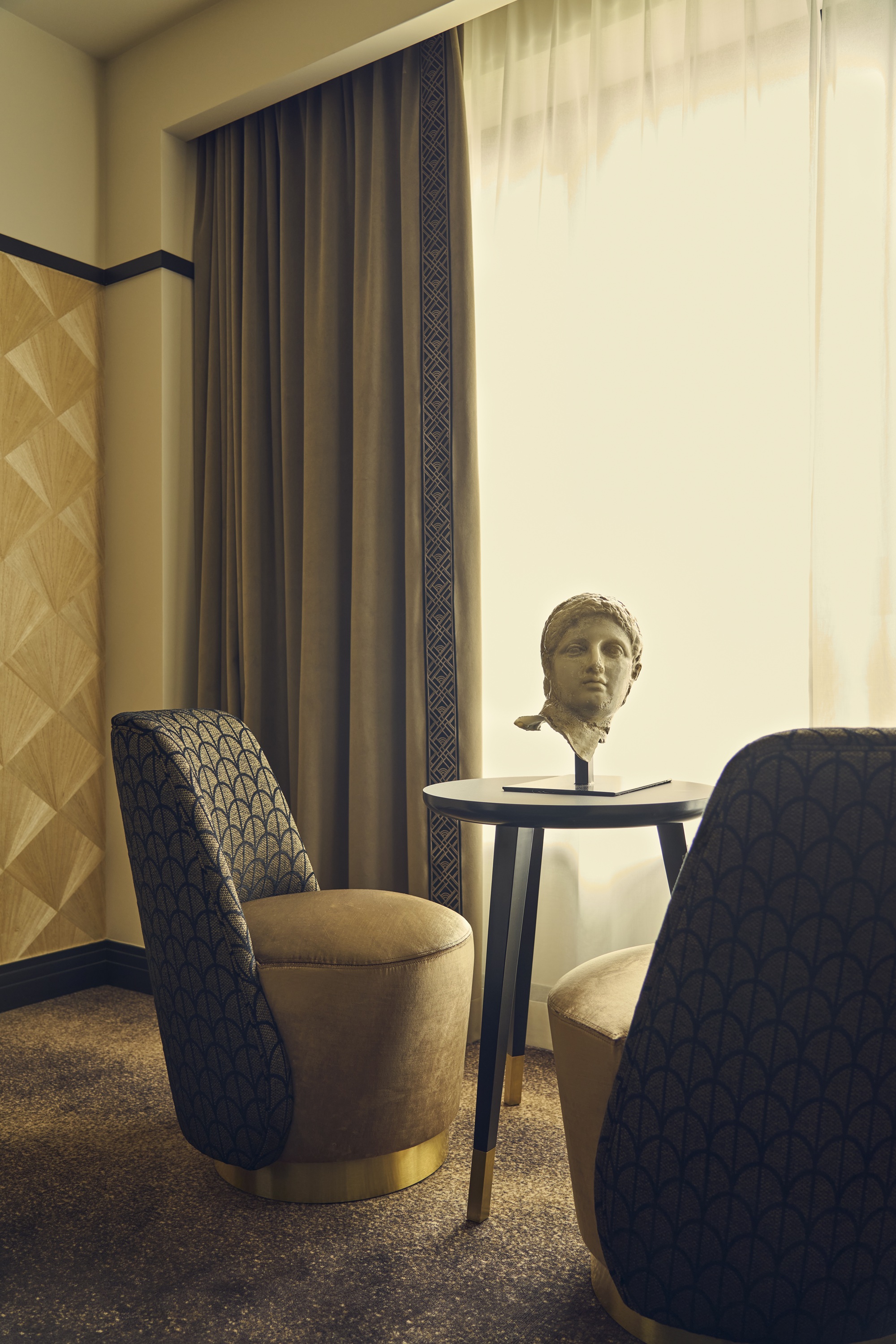 an art deco hotel bedroom with an art deco wallpaper and contrast black trim