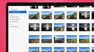 An Apple laptop screen showing a grid of photos