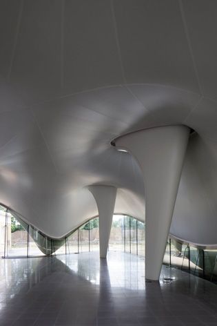 Curvy roof and interior of art gallery
