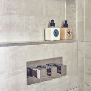 bathroom with rack on tiled wall