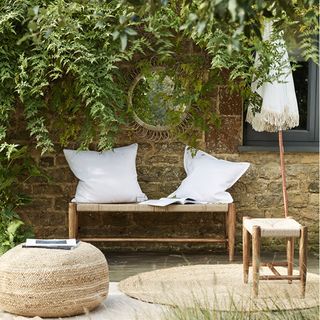 garden brick wall with bench and wall mirror