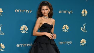 Zendaya poses in an elegant black dress on the red carpet at the 2022 Emmys. 