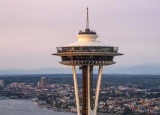 A landscape shot of the Space Needle with the city in the distance.