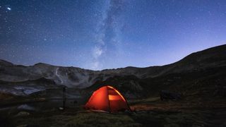 tent pitched in winter beneath starry sky