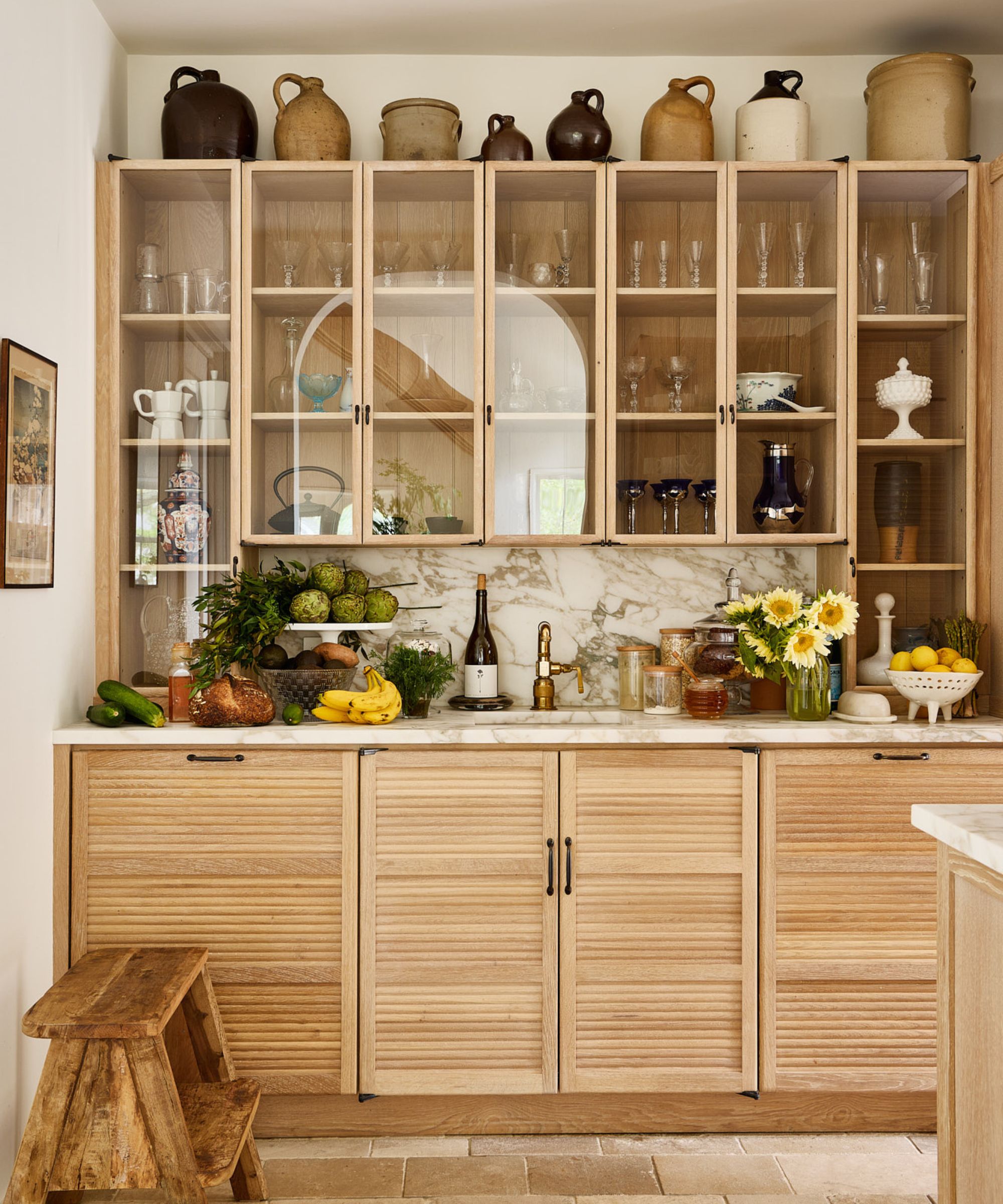 A wooden pantry attached to a Coastal Scandinavian kitchen