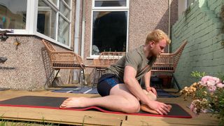 Fit&Well writer Harry Bullmore doing a figure-four stretch - a variation on the 90/90 stretch