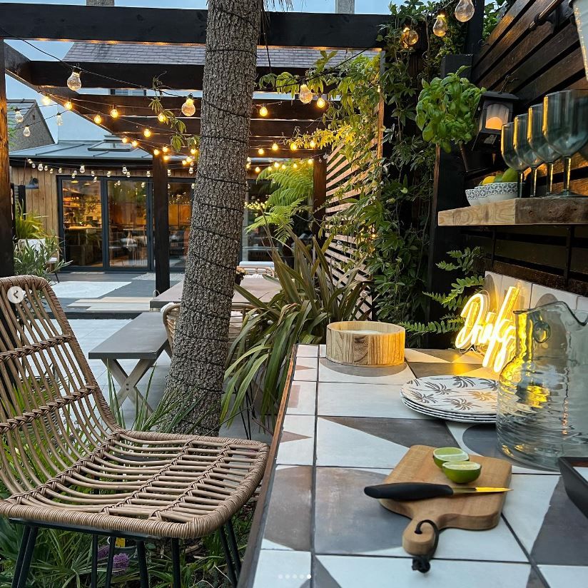 An outdoor area chairs and overhead sun shade