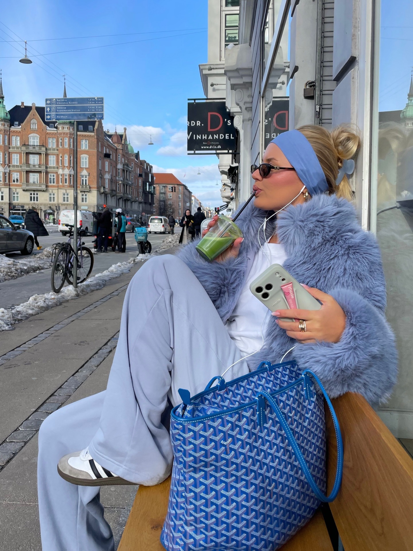 Fashion person Barbara Kristoffersen wears a trending trainer brand 2026. She wears adidas sambas. She wears them with blue tracksuit bottoms, a white tank, blue fur jacket and blue headband. This image was recently taken from her Instagram.