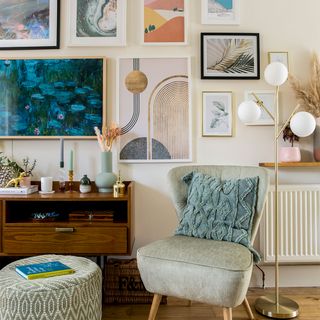 living room gallery wall with armchair and lamp