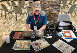 Pat Malach works in press room at 2019 Larry H. Miller Tour of Utah