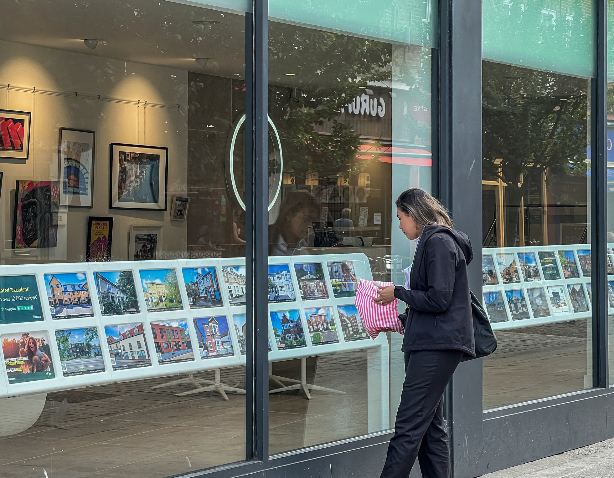 Woman looking at estate agent window
