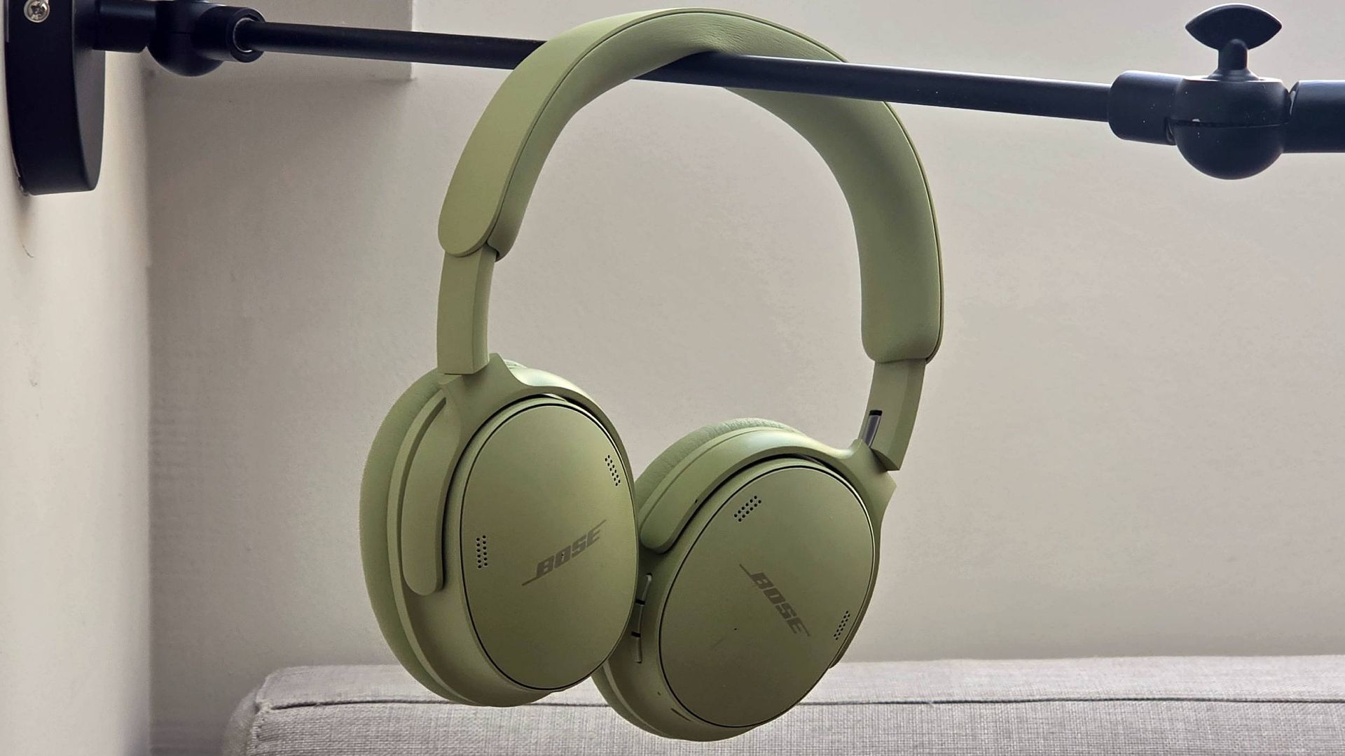 The Bose QuietComfort Headphones (2nd Gen) hanging from a bar.