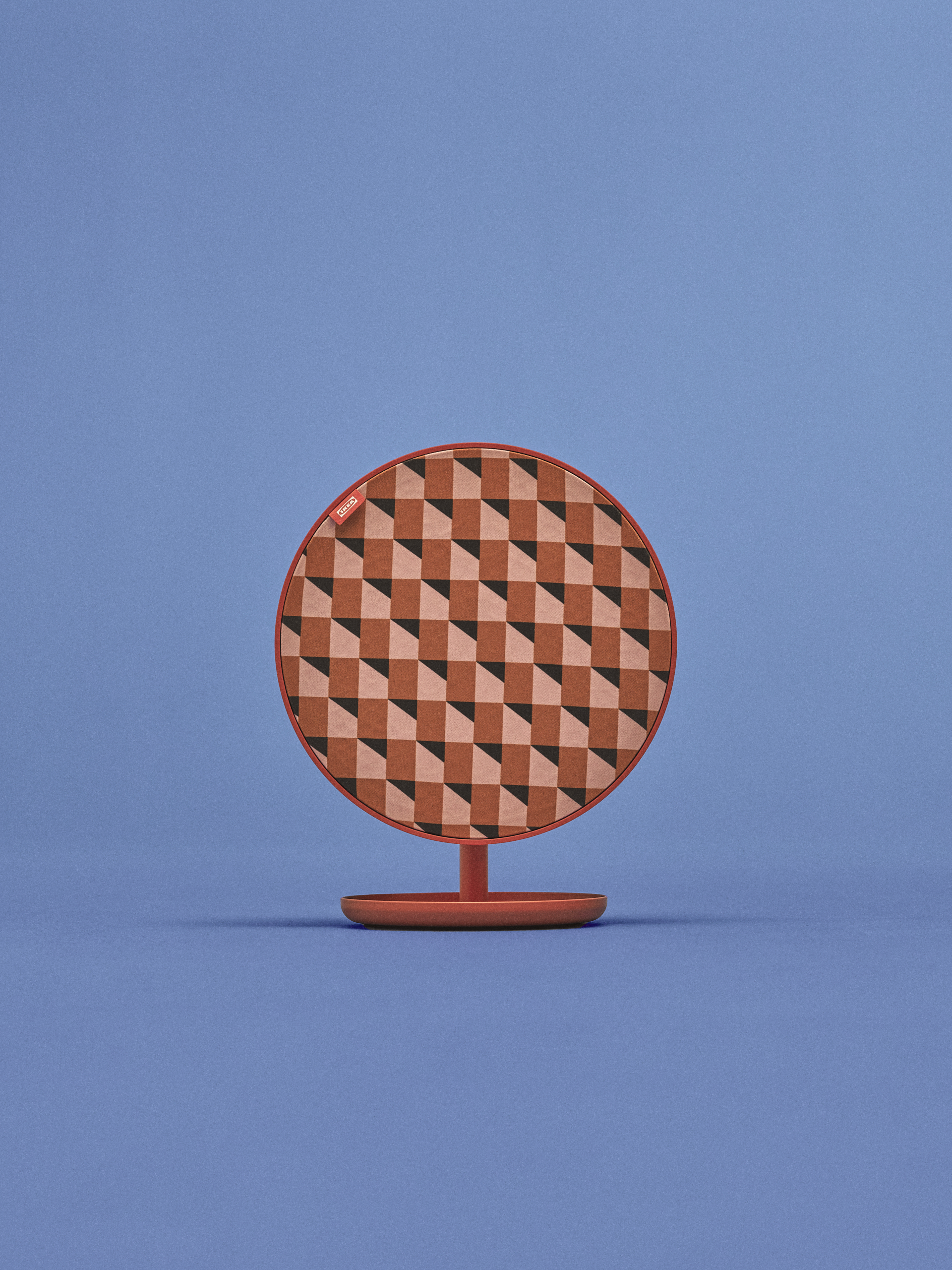 A speaker covered in a coral-coloured geometric pattern set against a blue backdrop