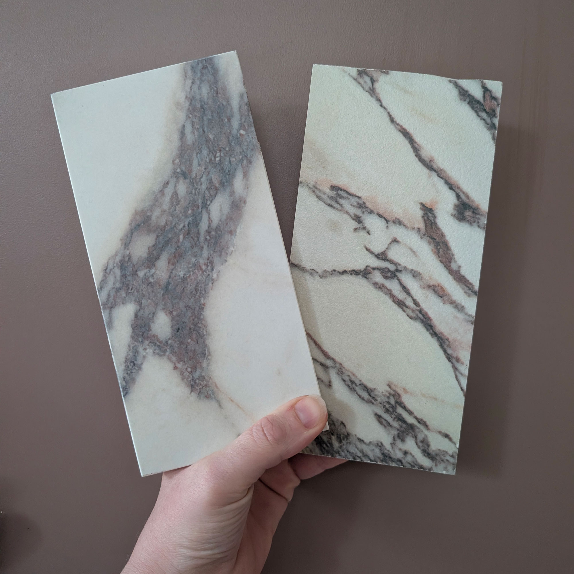 Two marble samples being held up