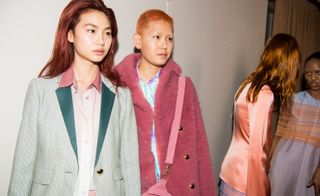 Models can be seen in coloured tailored jackets and an oversized pink teddy coat with gold buttons