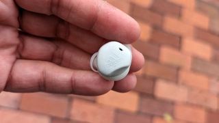 The Adidas FWD-02 wireless earbuds being held in hand