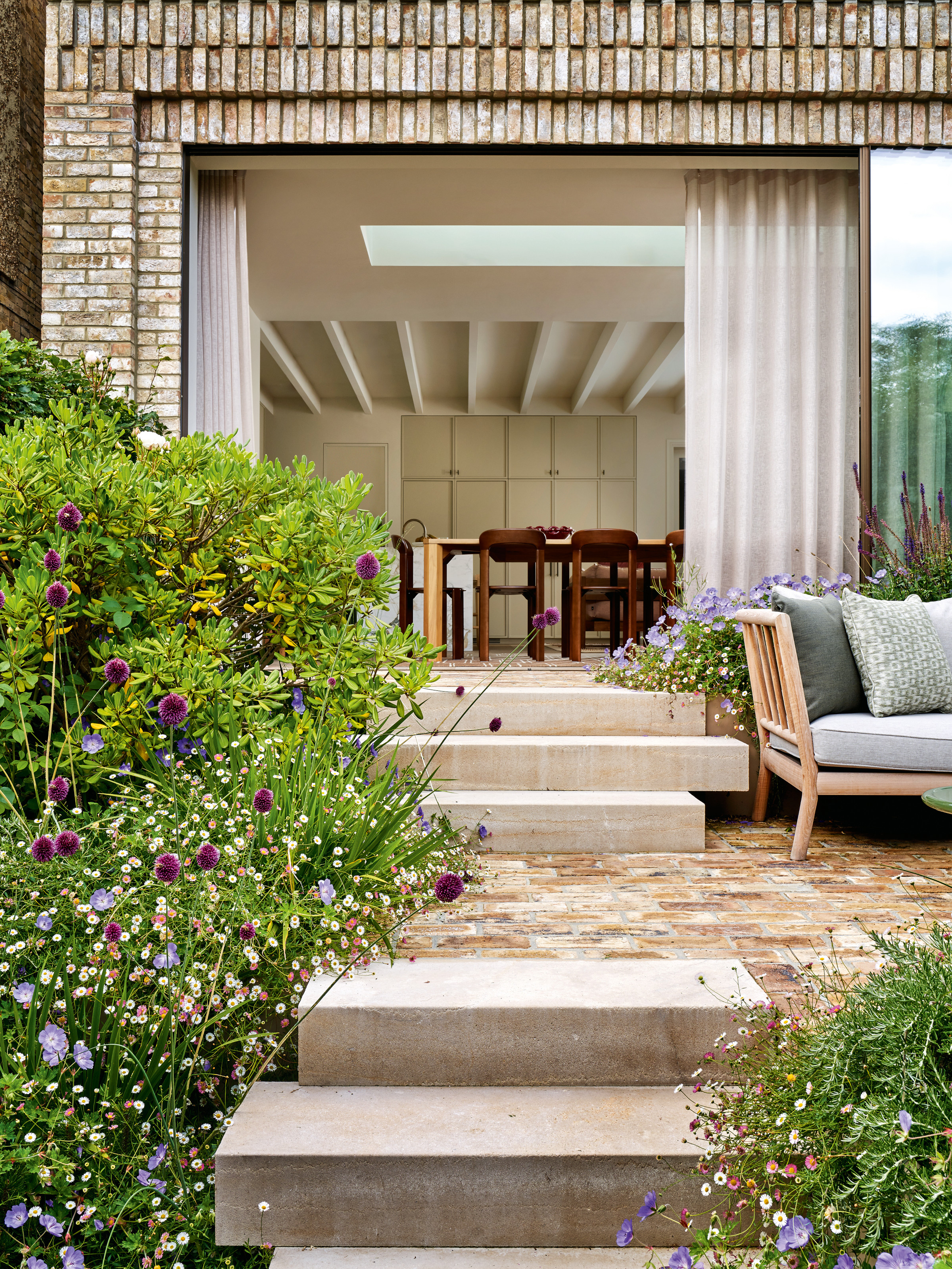 Stone steps leading to brick patio and extended kitchen-diner
