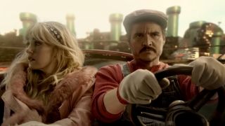From left to right: Chloe Fineman as Princess Peach sitting in the passenger seat and Pedro Pascal driving as Mario in Mario Kart trailer.