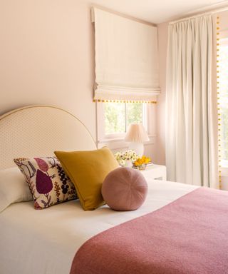 Pink bedroom, curtains with orange pom poms