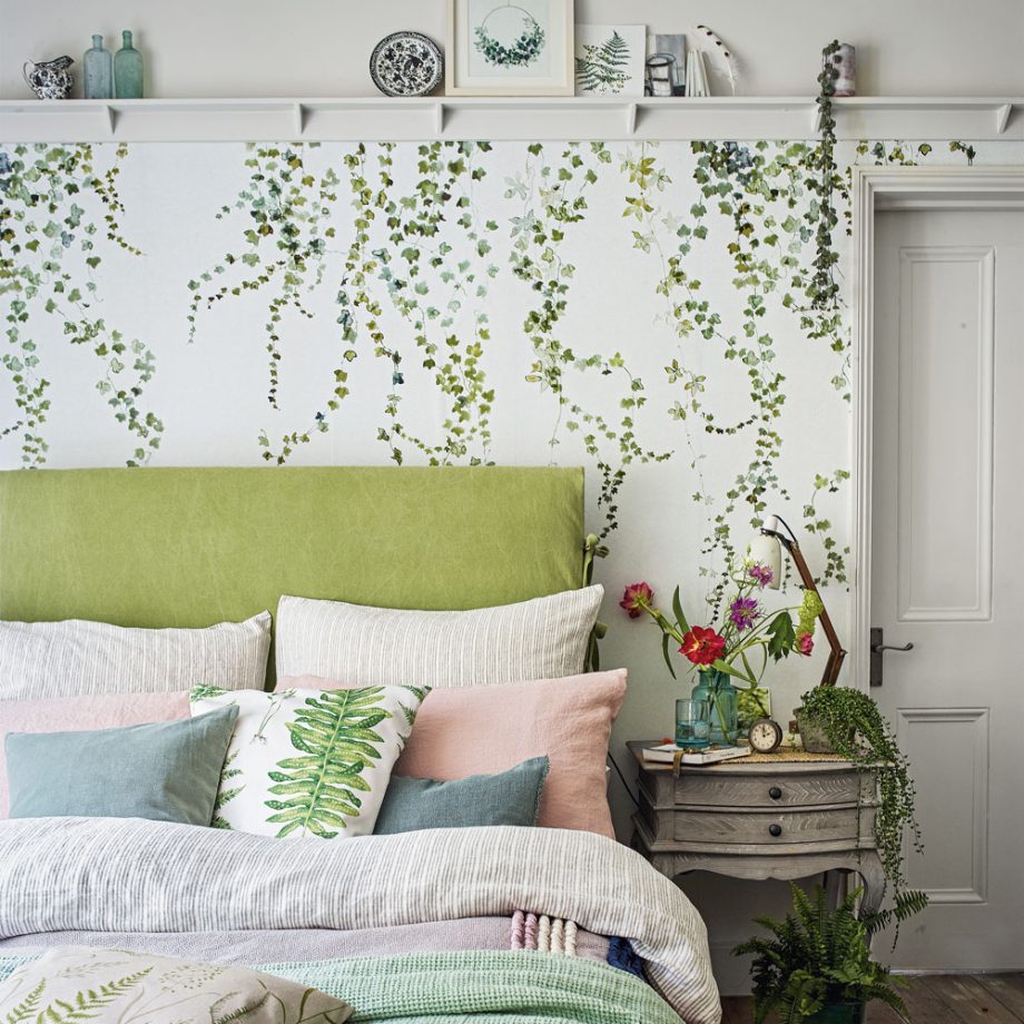 bedroom with leaf wallpaper and flower vase