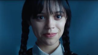 Jenna Ortega as Wednesday Addams in Wednesday smiling.