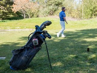 Man testing TaylorMade FlexTech Crossover stand bag