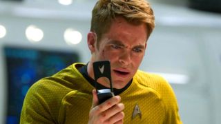 Chris Pine as Captain Kirk in Star Trek talking to a communicator