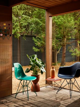 Eames plastic chairs from Herman Miller x Hay in green and blue, on terrace