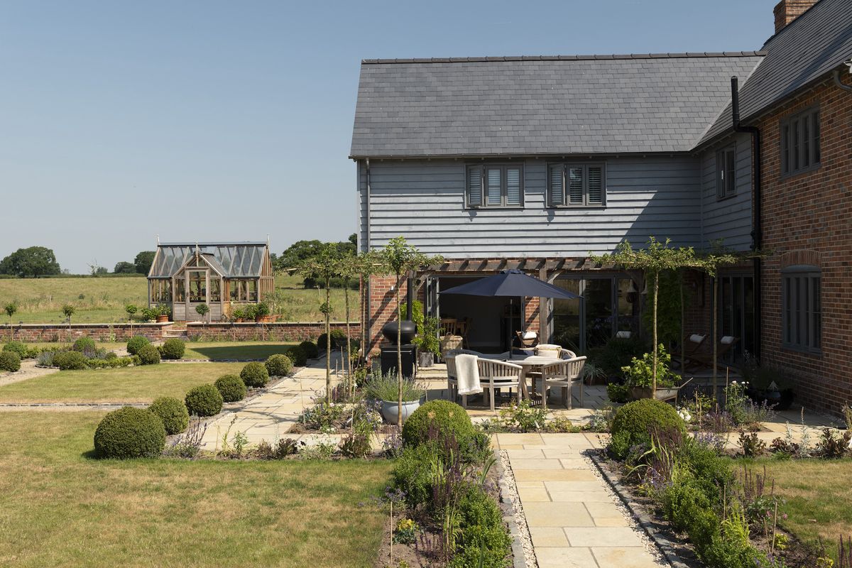 garden patio with pergola and pathway outside house