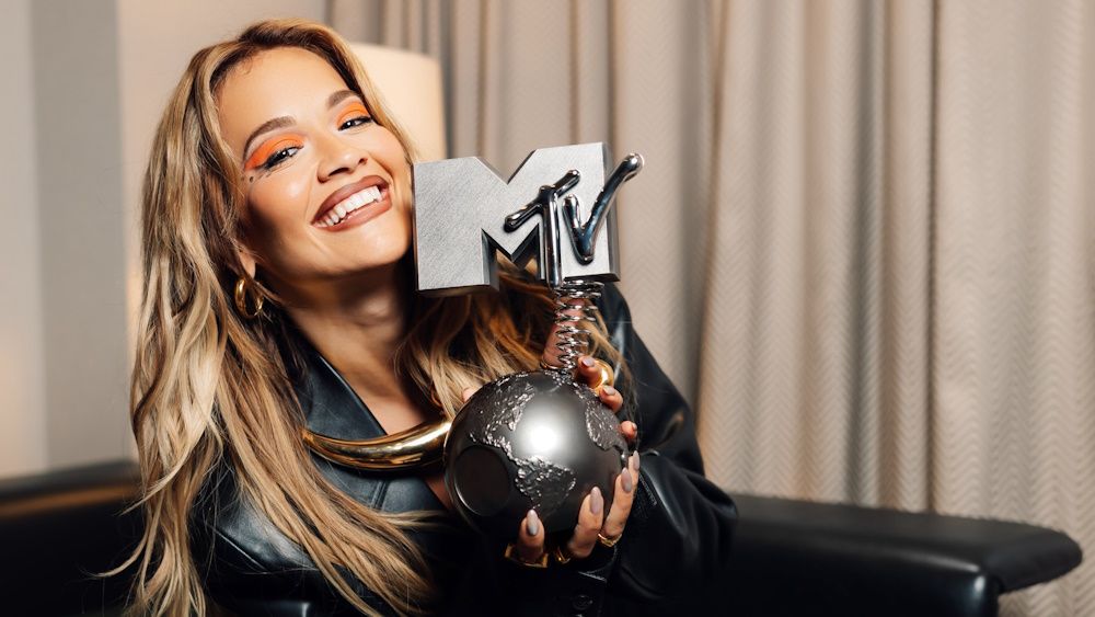 Rita Ora smiling and holding a MTV European Music Award ahead of the 2024 ceremony.