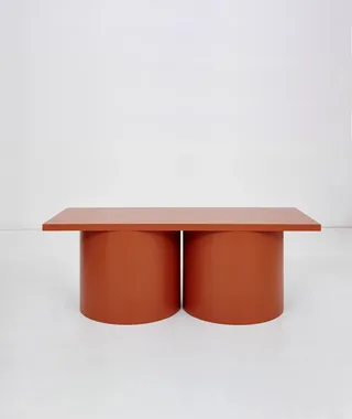 Chubby terracotta-coloured table on grey background