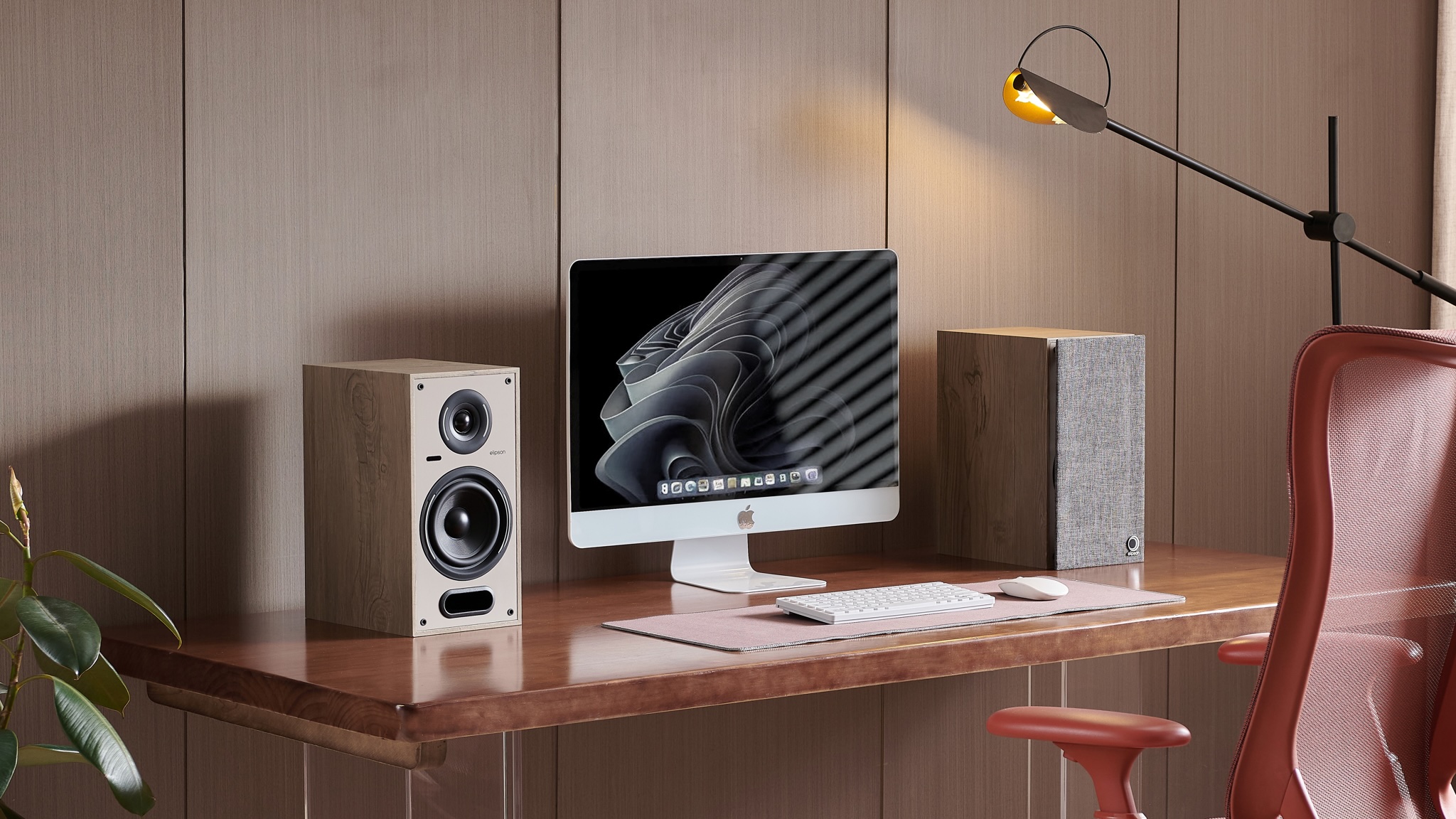 Elipson Horus 6B Active BT speakers on either side of an iMac computer on a wooden desk