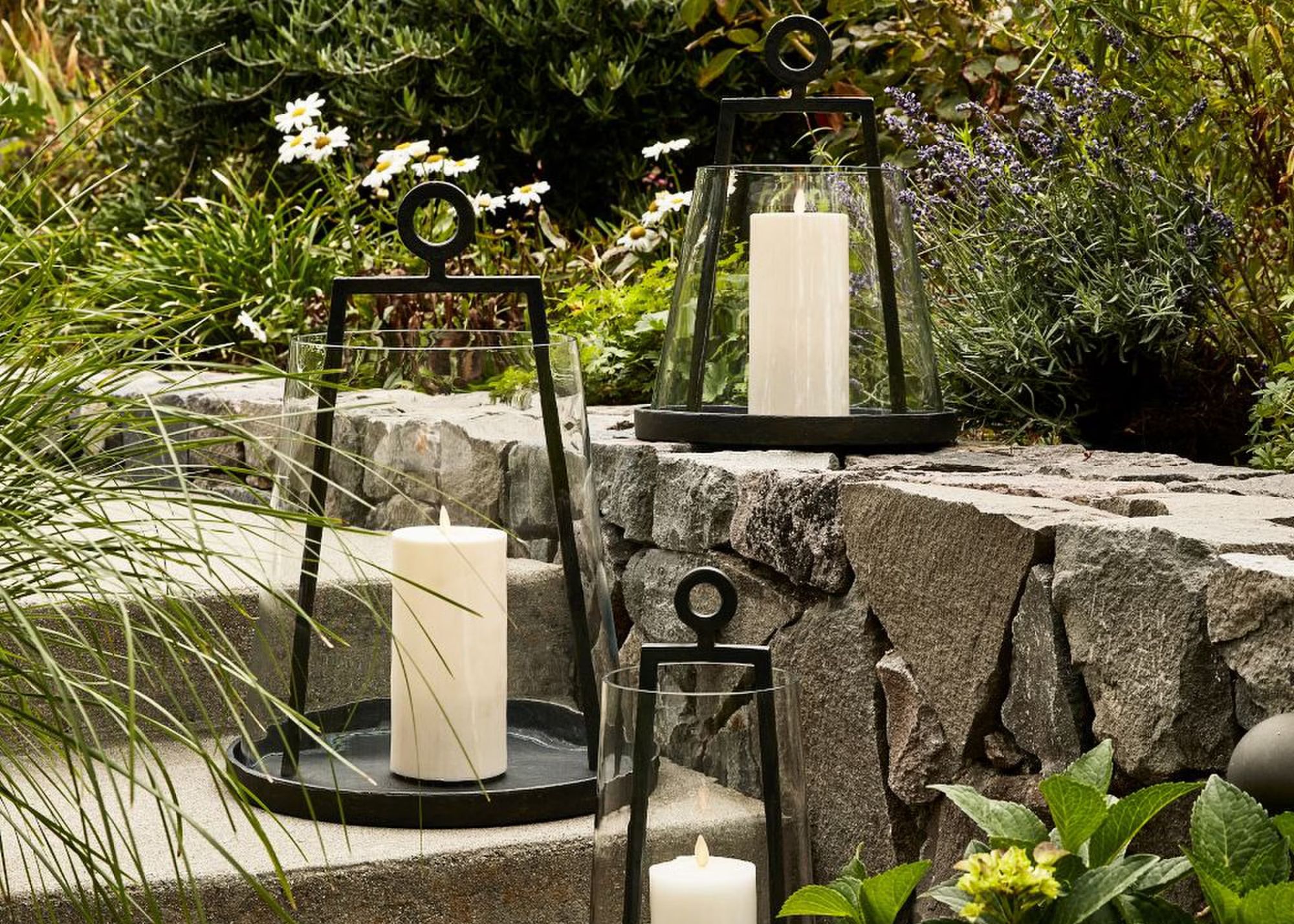 A set of three forged-iron outdoor lanterns from Pottery Barn