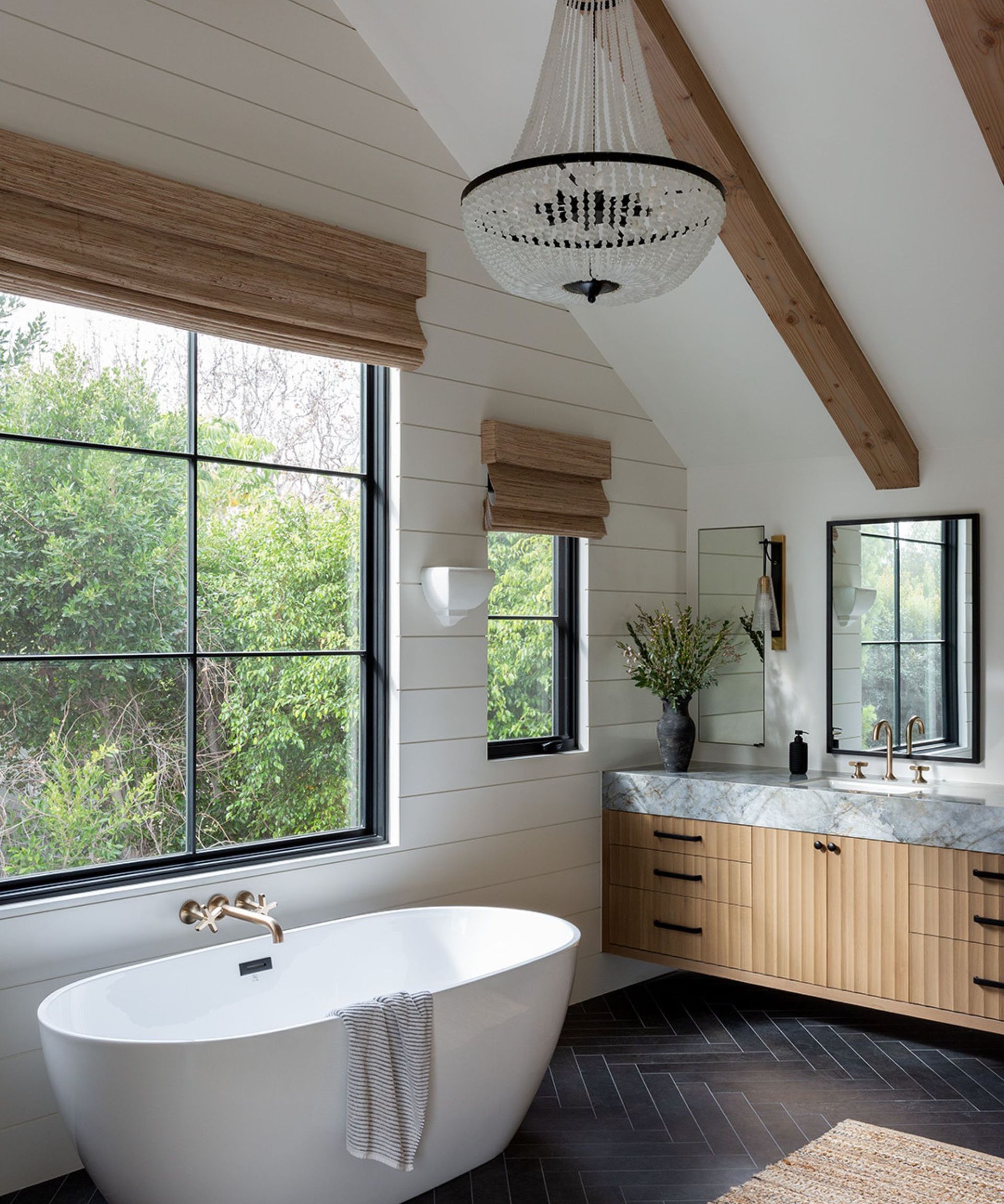 bathroom with beams and chandelier