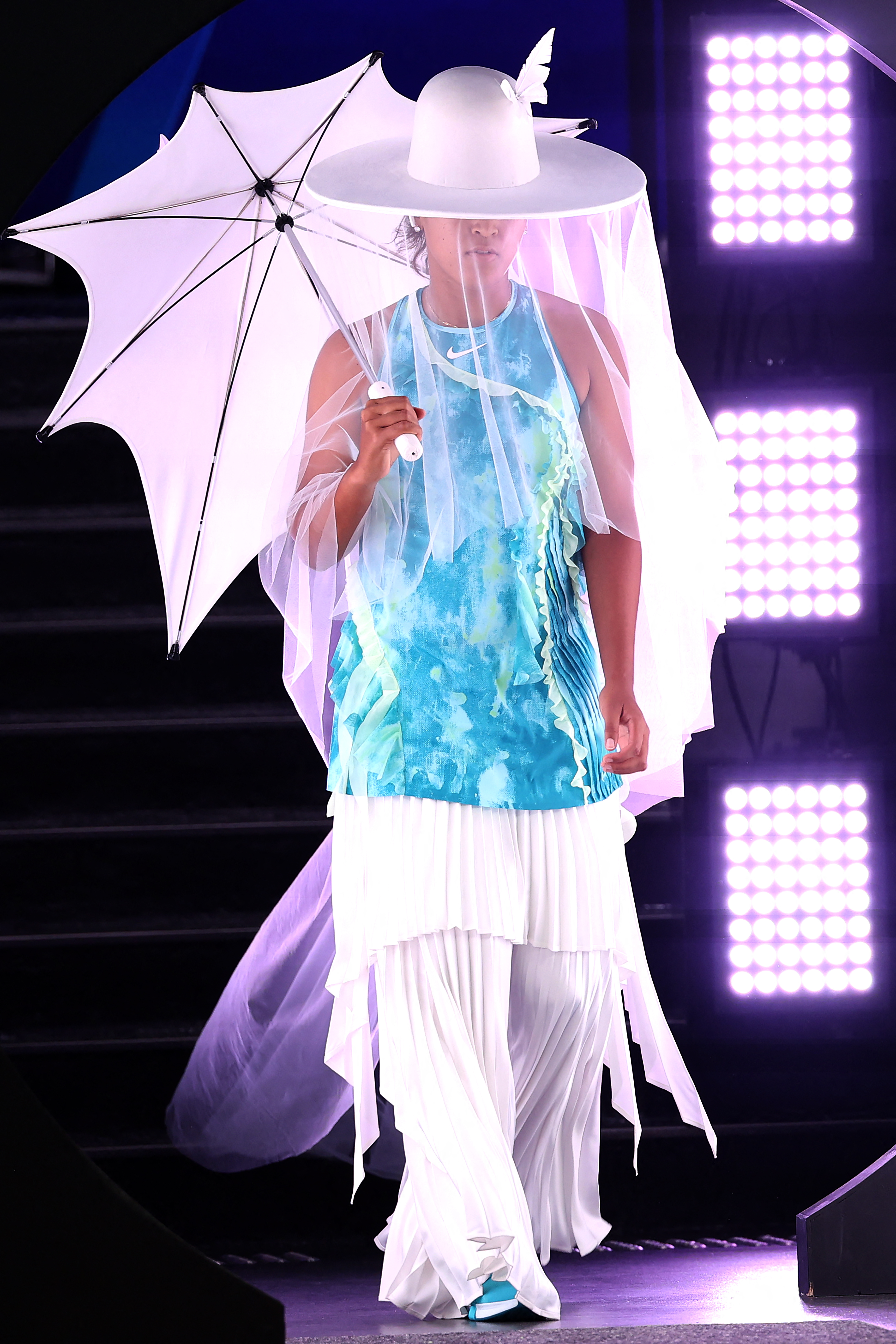 Naomi Osaka arrived at the 2026 Australian Open in a Robert Wun hat and umbrella, before revealing her tie-dye Nike athleisure
