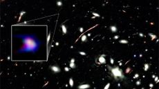 A deep space photo with a boxout to the left encircling a smear of blue and purple light.