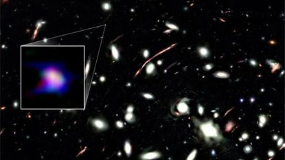 A deep space photo with a boxout to the left encircling a smear of blue and purple light.