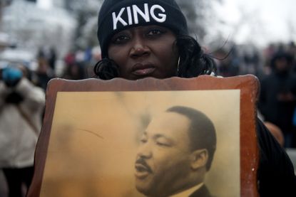 A woman holds a picture of Martin Luther King