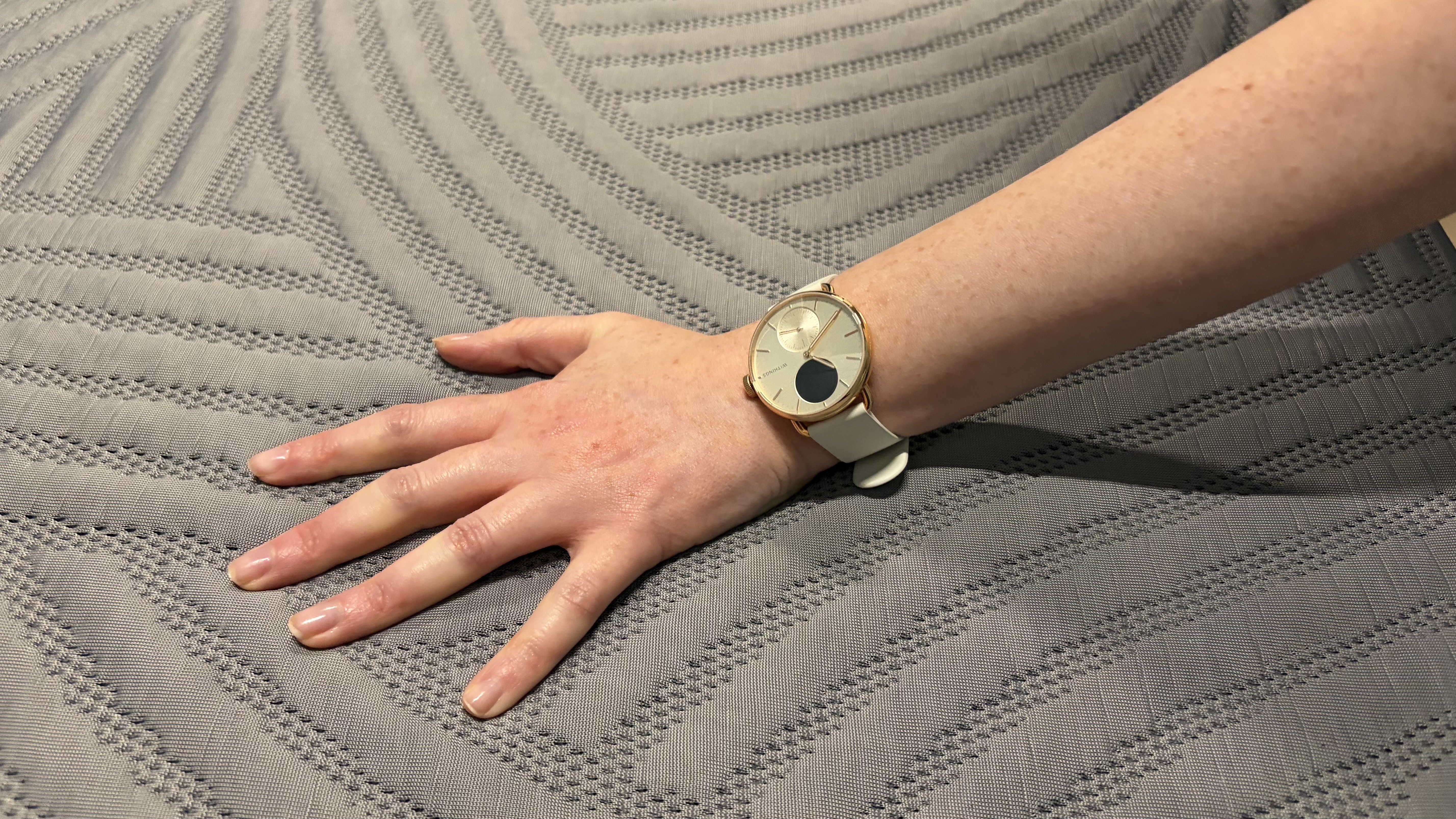 A woman's hand feeling the surface of the SweetNight CoolNest Mattress's surface.