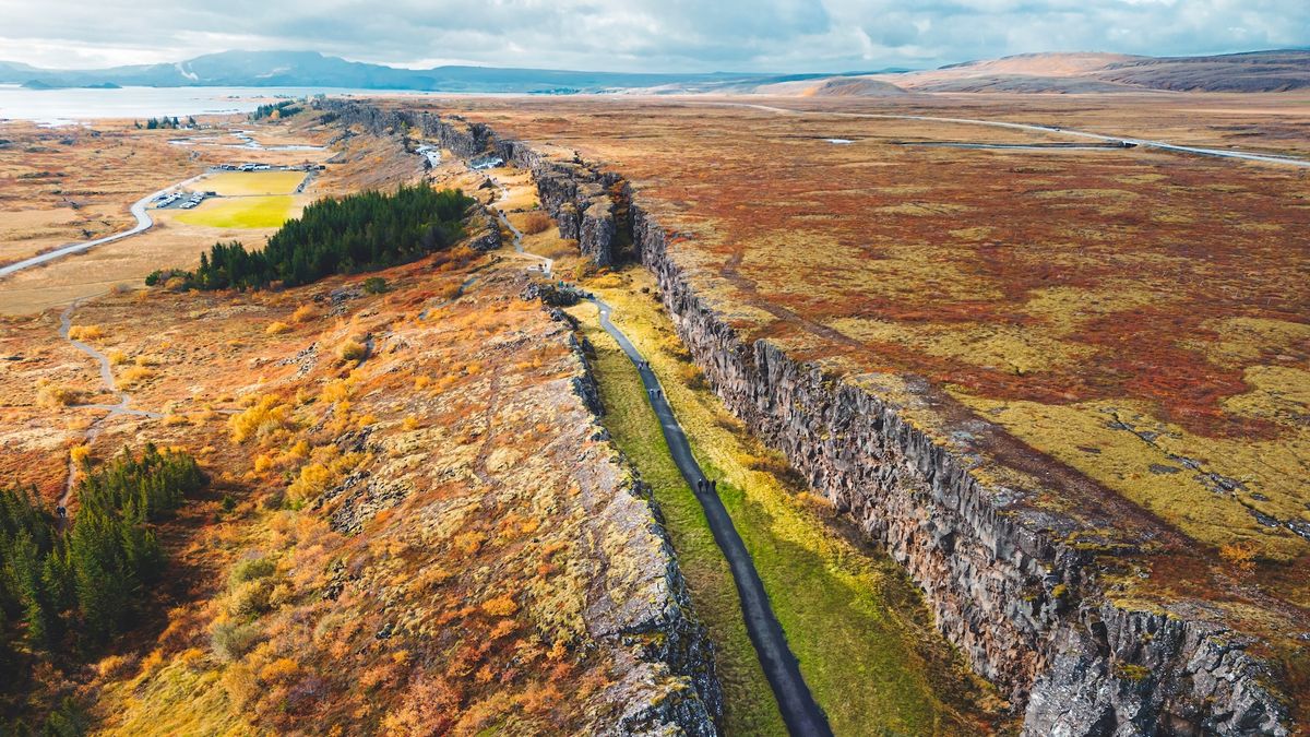 An aerial view of a road that travels along a rift in the landscape