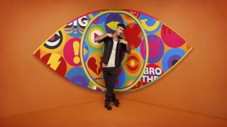 Zak in front of the Big Brother logo.