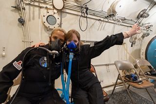 Inspiration4 crewmembers Sian Proctor and Hayley Arceneaux as seen during altitude chamber training before flight. During the three day mission, Proctor, Arceneaux and their companions will conduct a range of medical research.