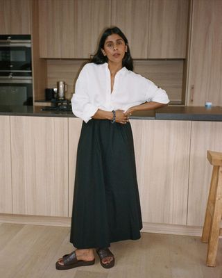 @monikh wearing a black skirt and white shirt