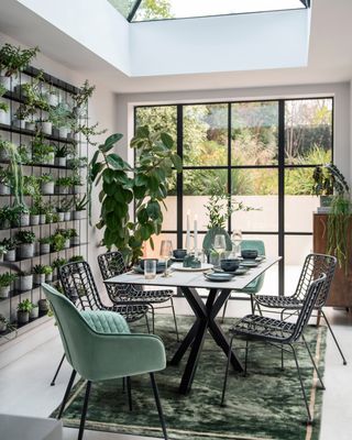 dining room with Crittal style doors and a plant wall