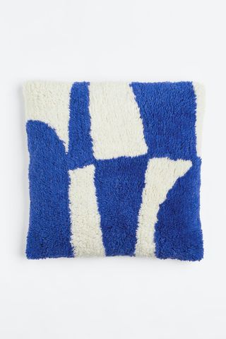 Tufted wool cushion in bright blue/white