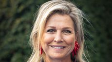 Queen Maxima's navy jumpsuit with ruby red pumps